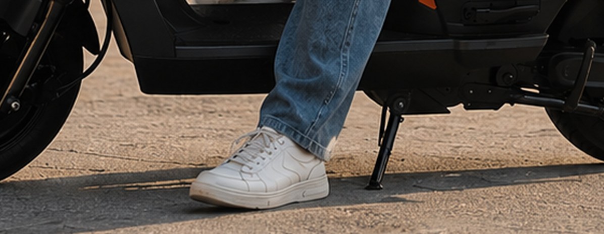 Side stand lowered next to a rider's foot